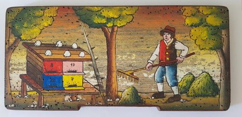 Bemalte Bienenstockstirnbretter - das Bienenhaus im Feld